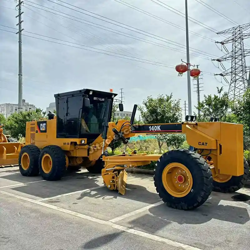 Full side view of a CAT 140K grader, a top choice for those browsing used forklifts for sale.
