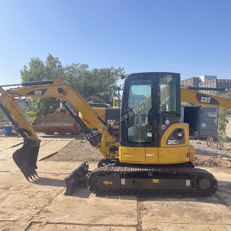 Side view of a yellow CAT 304CR used mini excavator for sale.