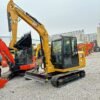 CAT 306 Profile View Side profile of a yellow CAT 306 mini excavator for sale used.
