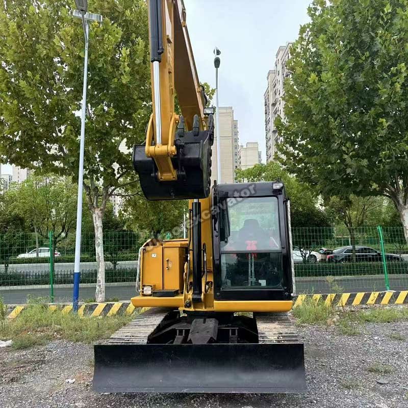 Front view of a yellow CAT 308E2 from our inventory of used compact excavator for sale.