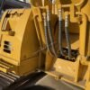 Cat 313C Hydraulics Detailed view of the auxiliary hydraulic lines on a Cat 313C for auger use.