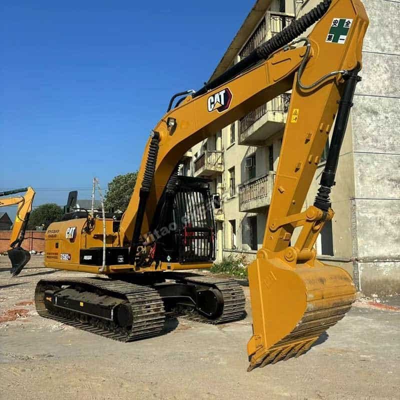 Side view of Cat 315D2, a heavy-duty alternative to a tractor post hole digger used for farming.
