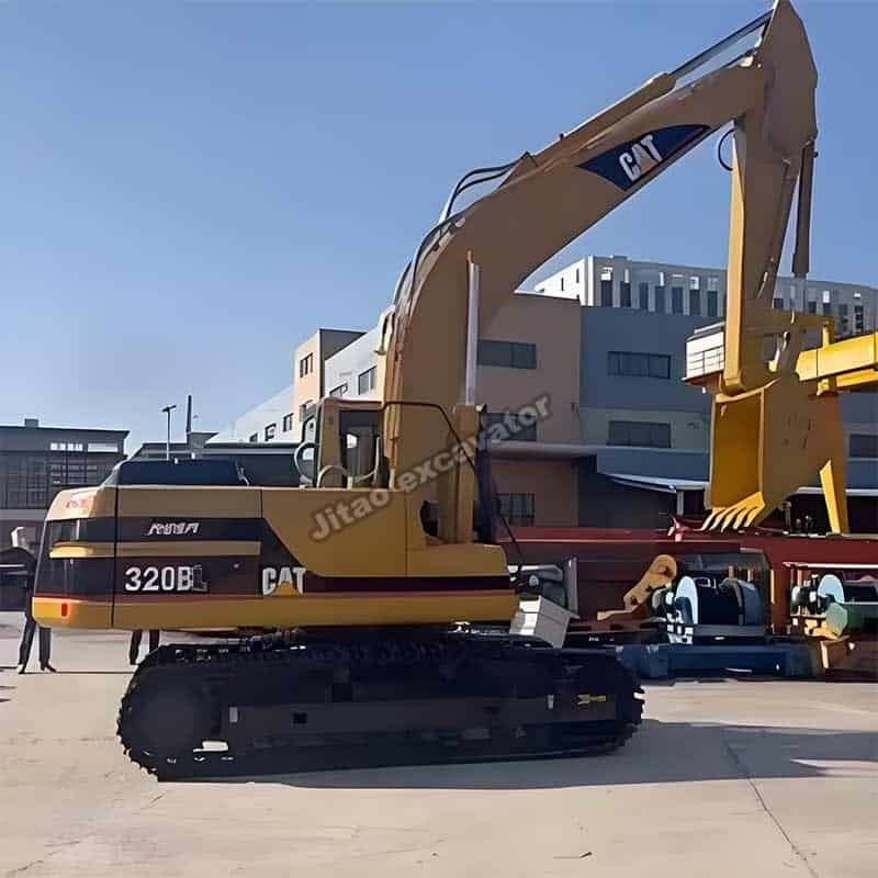 Full side profile of a yellow Cat 320BL, a heavy-duty used hole digger platform.