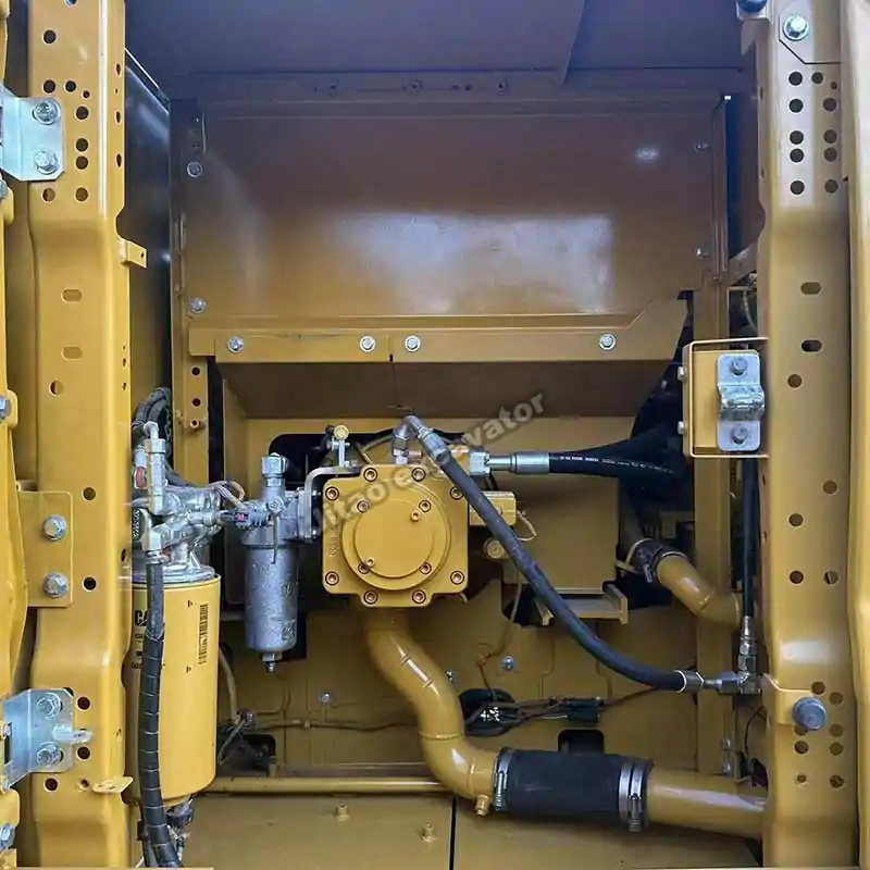 Interior view of the Cat 323 engine bay and hydraulic pump system.