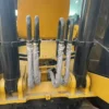 Close-up of the Cat 323D2 boom cylinders and hydraulic connections.