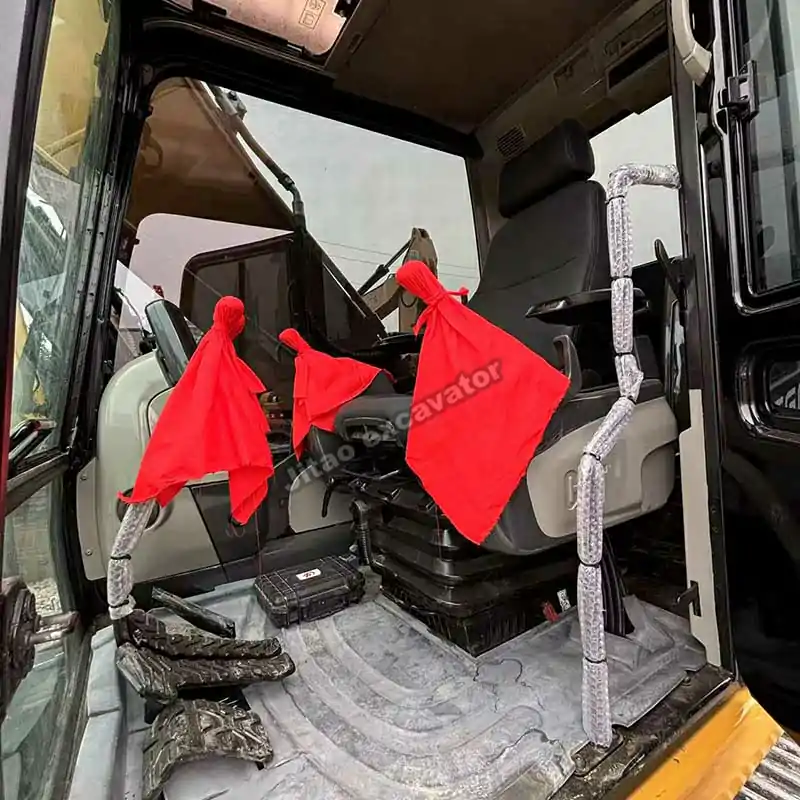 Interior of the Cat 325D2L cabin showing the joystick and seats.