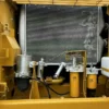 Close-up of the Cat 325D2L engine bay, radiator, and filters.