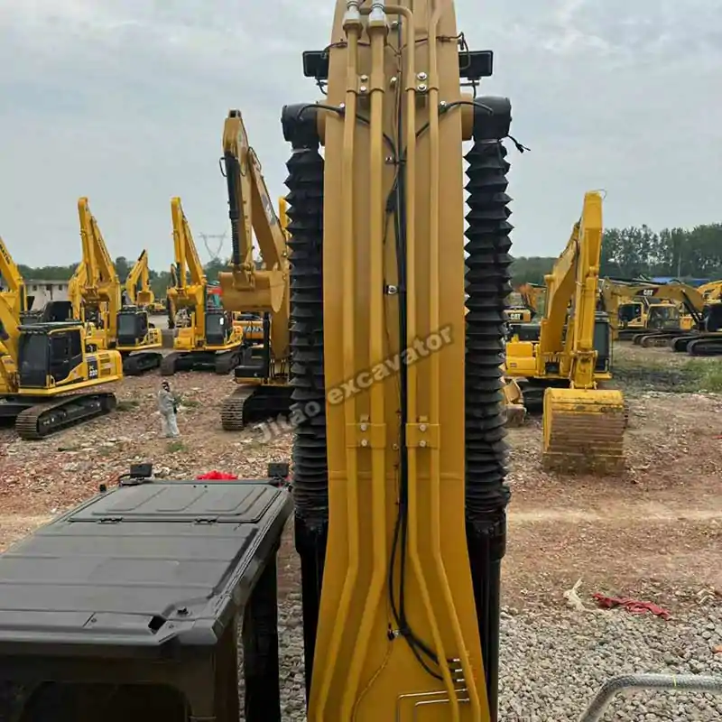 Close-up view of the Cat 330GC boom and bucket hydraulic cylinders.