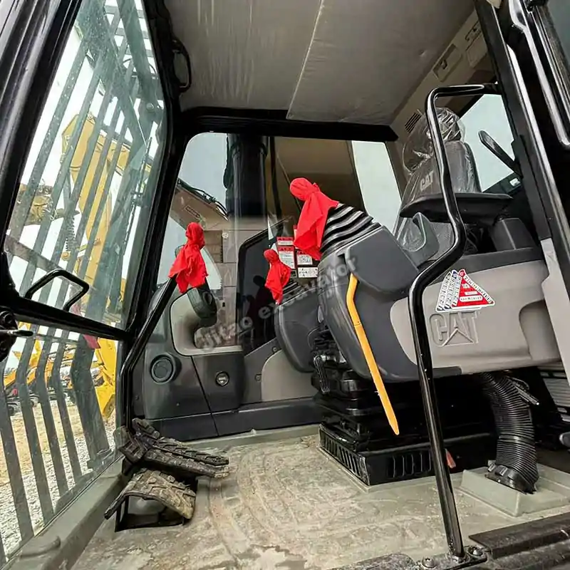 Interior of the Cat 340DL operator cab, showcasing its clean and modern cabin.