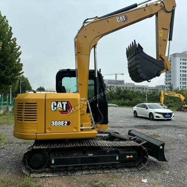Side view showing the engine housing and boom of a used compact excavator for sale.