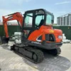 Front-quarter view of the Doosan DX60, verified and job-ready.