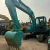 Durable Excavation Setup Angle view of the Kobelco SK130 bucket and reinforced crawler system.