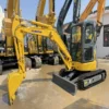 Certified PC35MR Profile Perspective view with blade down on this mini excavator used for sale.