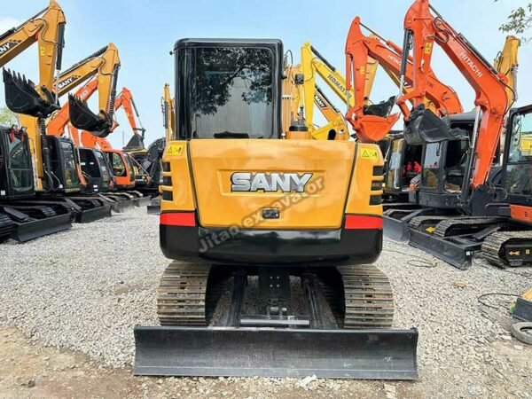 Rear view of a yellow Sany SY55C with original counterweight and engine housing.