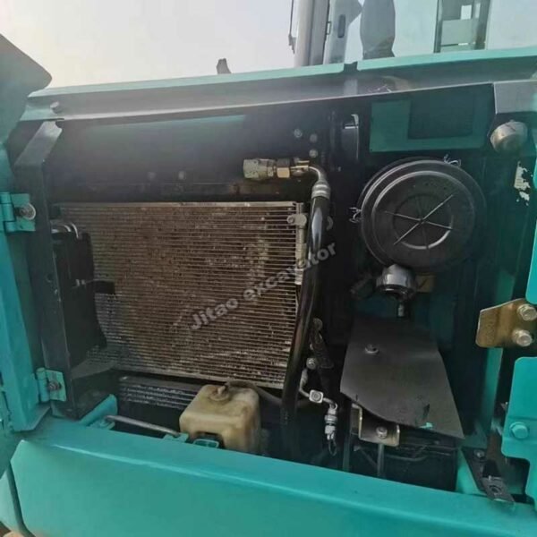 Interior view of the engine compartment and radiator of a Kobelco SK60.
