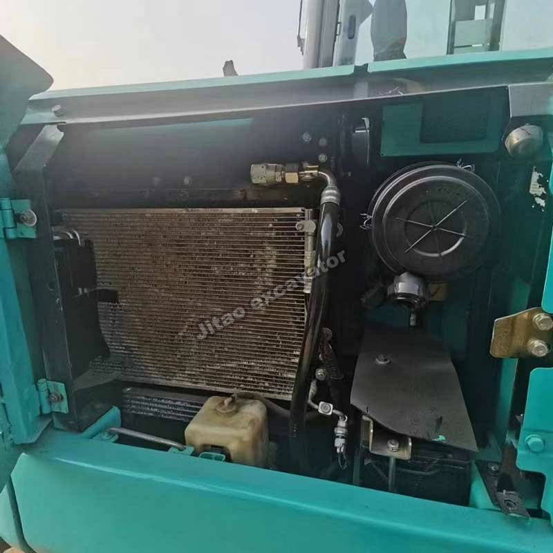Interior view of the engine compartment and radiator of a Kobelco SK60.
