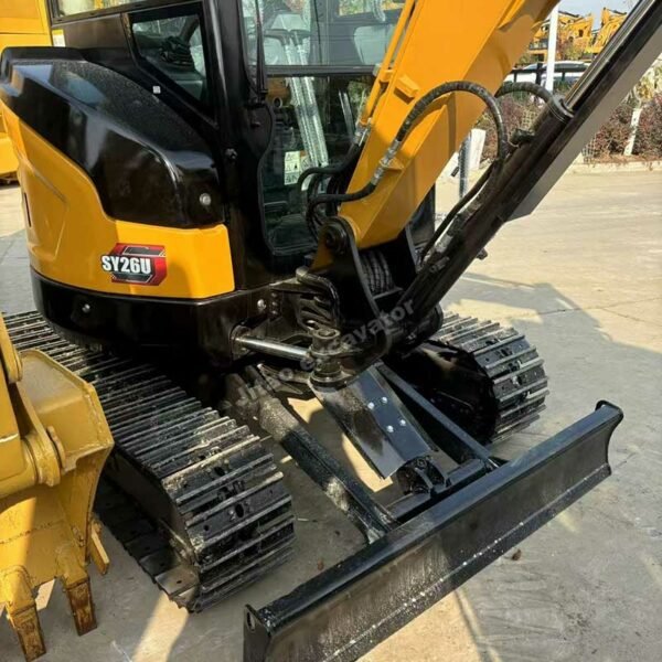 Front profile of a Sany SY26U showing the dozer blade and rubber tracks.
