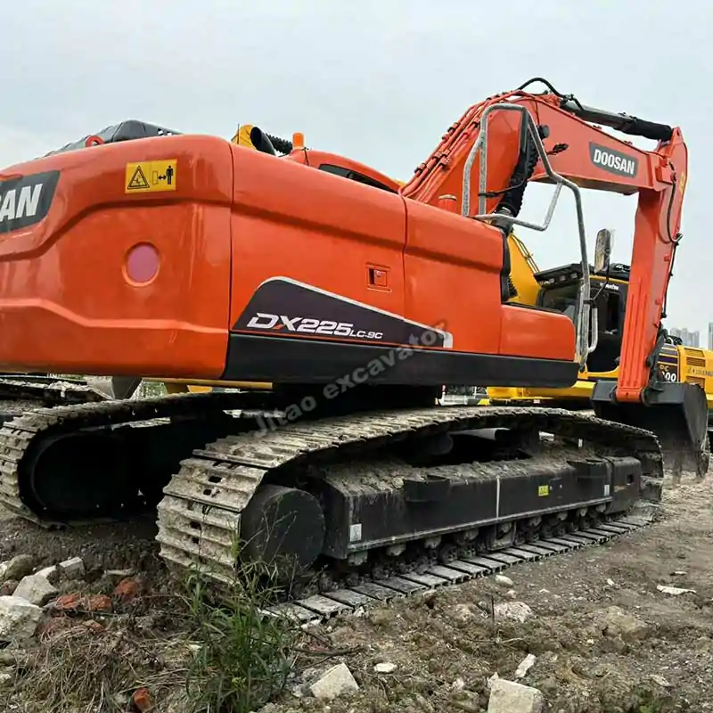 Side profile of the Doosan DX225LC-9C showing the full crawler system.
