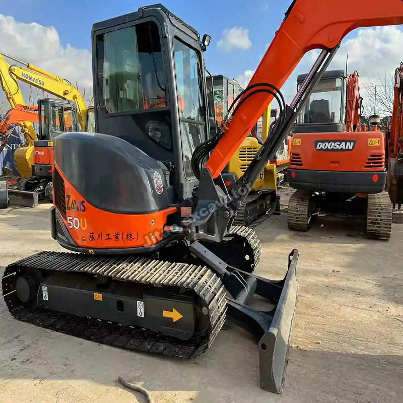 Rear perspective of used small excavators ready for export.