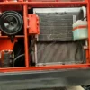 Engine and cooling system detail of a power wheels excavator.