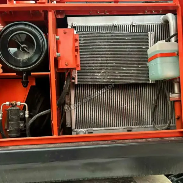 Engine and cooling system detail of a power wheels excavator.
