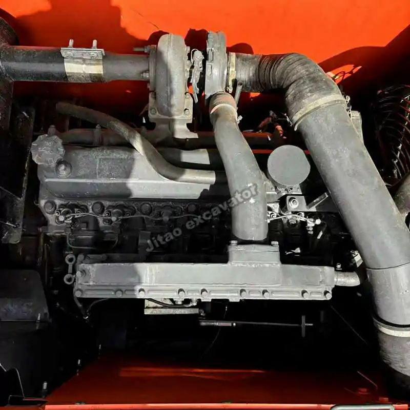 Close-up view of the Doosan DX225 engine and hydraulic pump compartment.