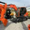 Front side view of a Doosan DX75, a top pick for mini excavators for sale used near me.