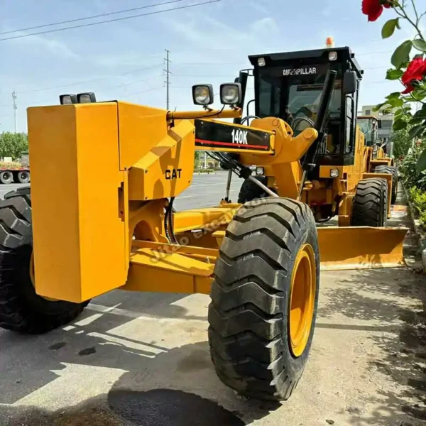 Reinforced Grading Blade Close-up of tires and blade on a CAT 140K grader representing used forklifts for sale.