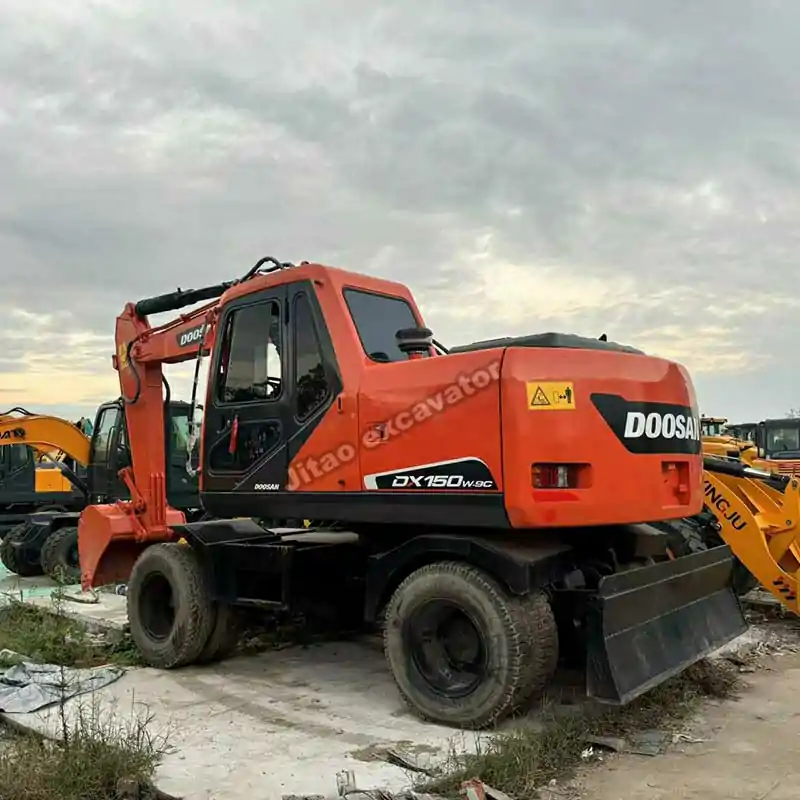 Rear perspective of a durable power wheels excavator in the yard.