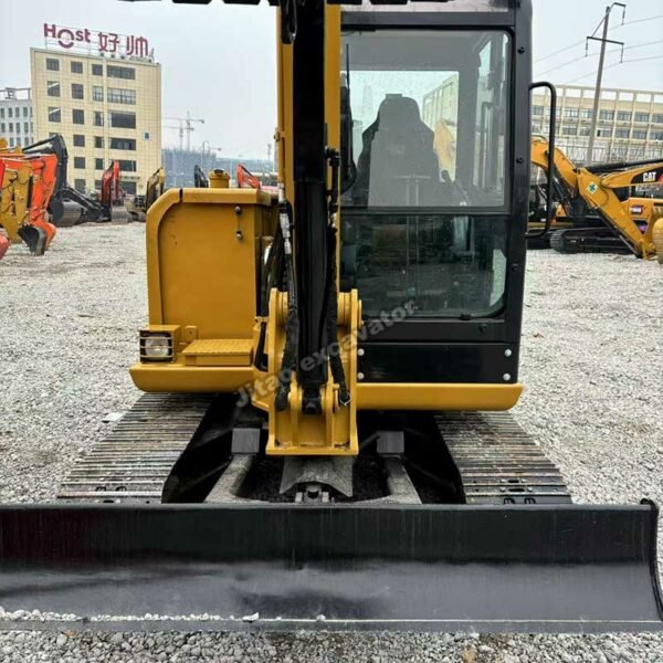 CAT 306 Front Profile Front view of a CAT 306 mini excavator for sale used showing dozer blade.