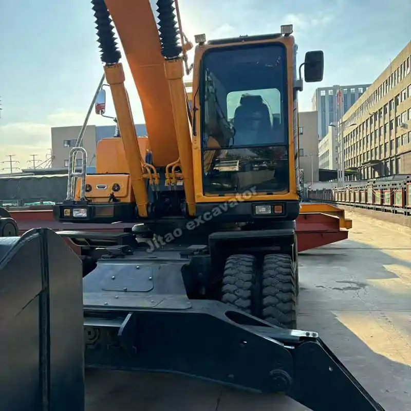 Rear view showing the stabilizers and axles of an excavator with wheels.