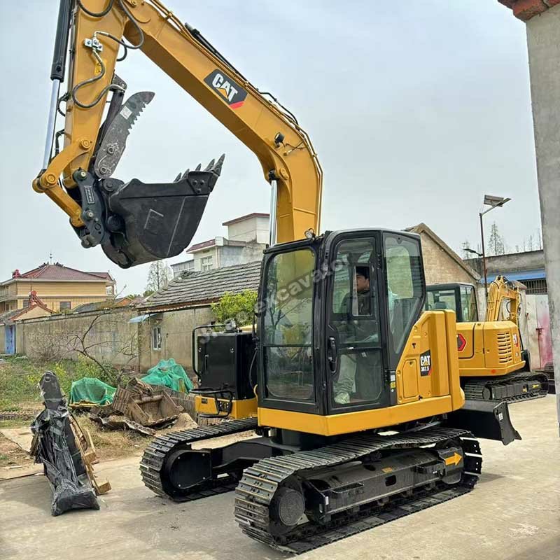 Side profile view of a certified CAT 307.5 used mini excavator.