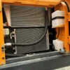 R220-9S Engine Bay Detailed view of the engine cooling block. Reliable hyundai excavator power.