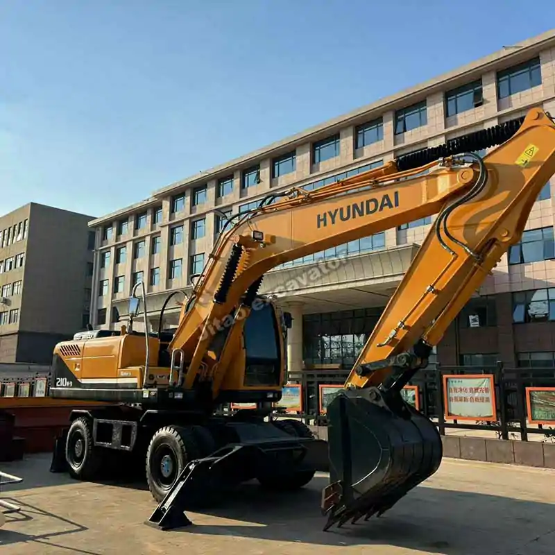 Front-left view of a Hyundai R210W-9 excavator with wheels.