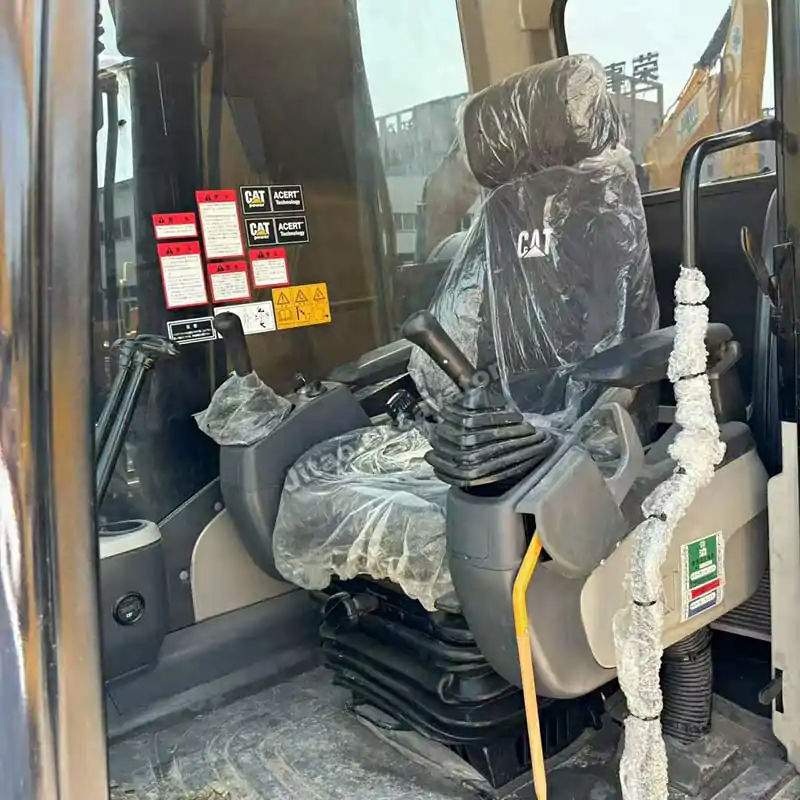 Comfortable operator station and clean cabin of Caterpillar 320D used excavator.