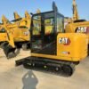 Side view of a yellow CAT 306E2 among our high-quality used excavators.