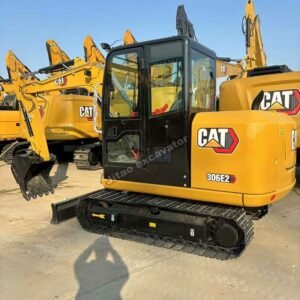 CAT 306E2 Used Excavators Side view of a yellow CAT 306E2 among our high-quality used excavators.