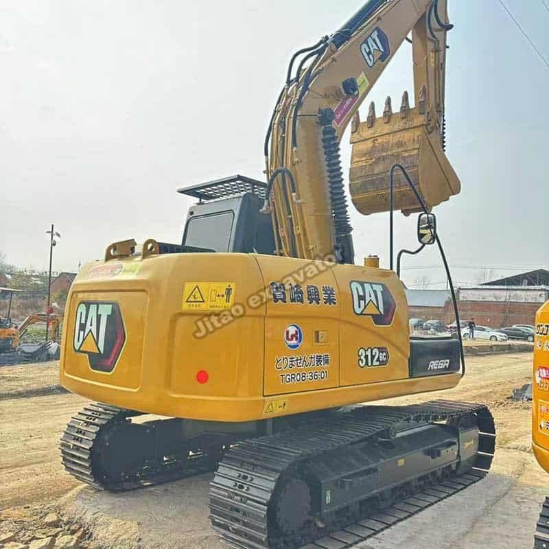 Rear-side profile showing the original paint and decals of a Cat 312 GC.