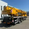 Rear view showing the boom and chassis of a certified mobile crane.