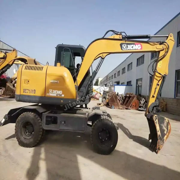 Three-quarter view of a certified wheeled mini excavator in the yard.