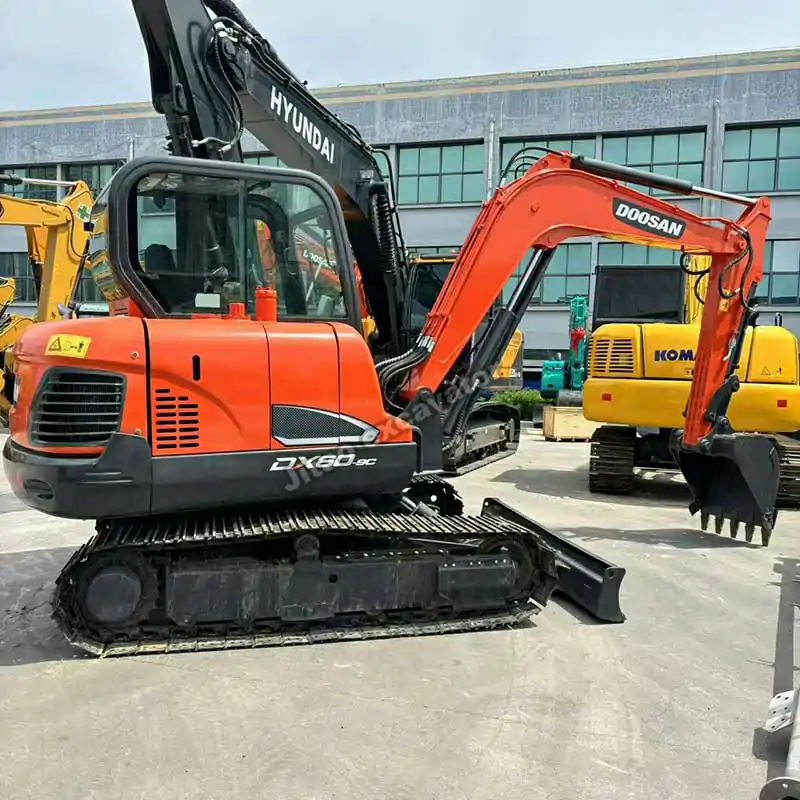 Side angle of the Doosan DX60 mini excavator showing its compact design.