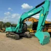 Three-quarter view of Kobelco SK260 crawler showcased in our used mini excavator for sale yard.