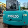 Rear profile of a certified Kobelco SK60 showing the counterweight and cabin structure.