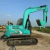 Side view of the Kobelco SK75 showcasing its pristine condition and durable boom.