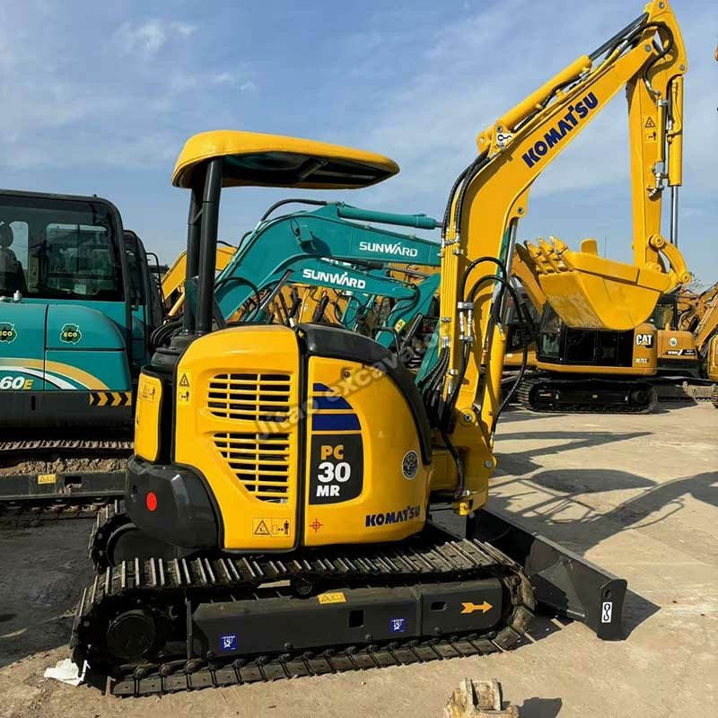 Rear view of a Komatsu PC30MR showing the compact tail and engine housing.