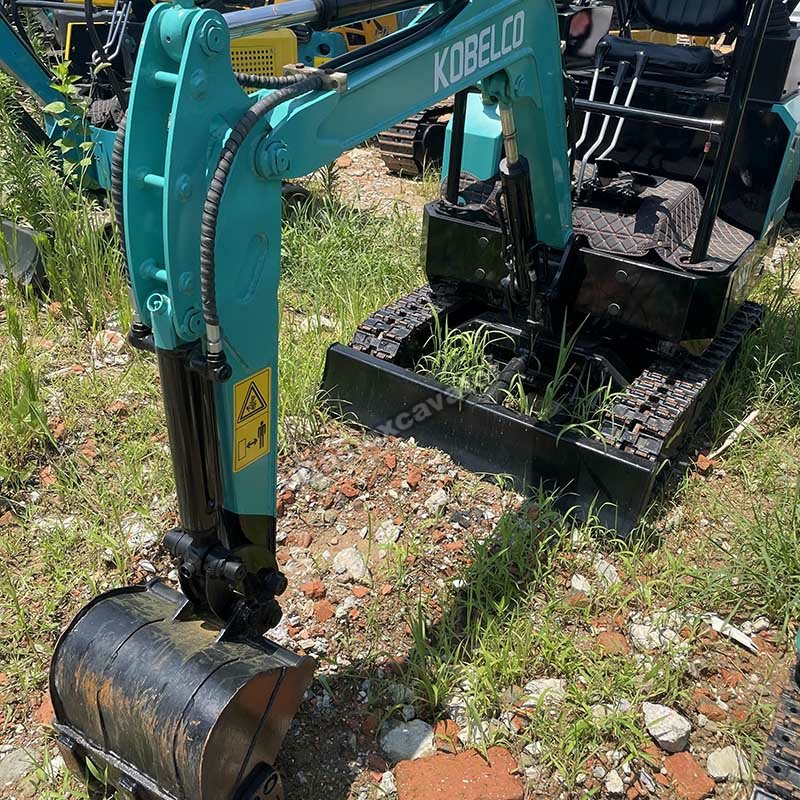 Close-up of the digging bucket and hydraulic arm of a Kobelco SK17.