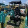 Side view of a turquoise Kobelco SK17, a premium selection of used mini excavators at Jitao.