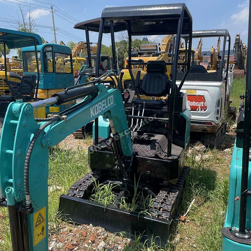 Side view of a turquoise Kobelco SK17, a premium selection of used mini excavators at Jitao.