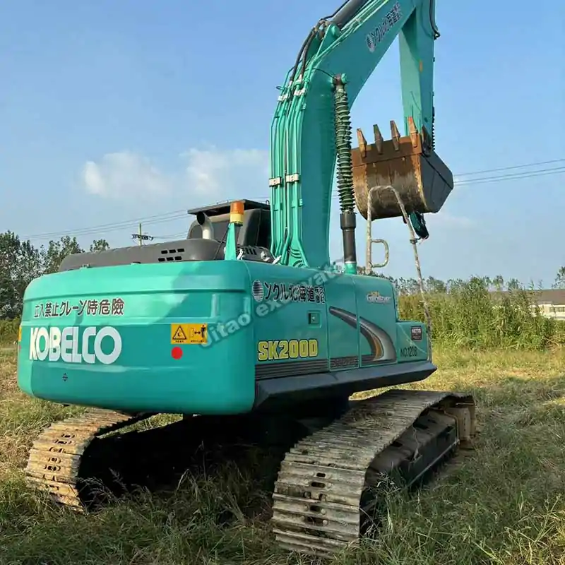 Angle view of the Kobelco SK200D tracks and boom, part of Jitao used chinese mini excavator for sale fleet.