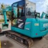 Full side view of a turquoise Kobelco SK60, a premium used compact excavator at Jitao.
